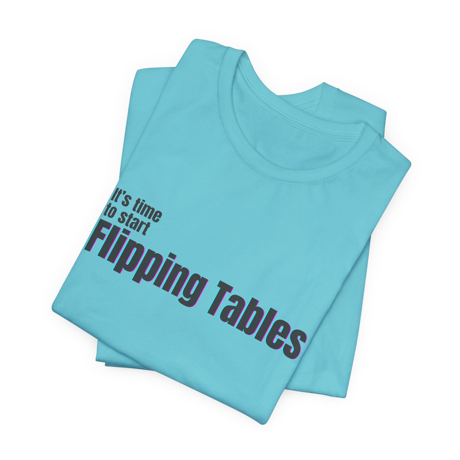 Folded turquoise t-shirt with text "It's Time to Start Flipping Tables" by empowHERbyHeidi