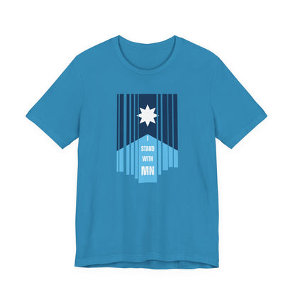 Blue t-shirt with a stylized Minnesota flag and text "I Stand with MN" by empowHER by Heidi