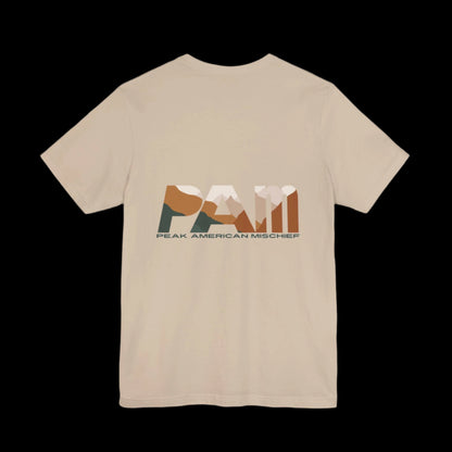 Tan  t-shirt with 'PAM' logo "Peak American Mischief" on the back against a black background