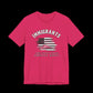 Pink t-shirt with American flag graphic and text that says "Immigrants are what make America Great" on a black background