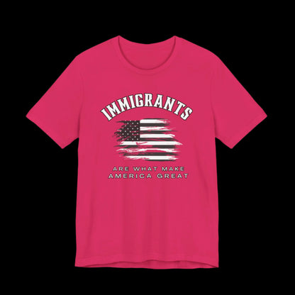 Pink t-shirt with American flag graphic and text that says "Immigrants are what make America Great" on a black background