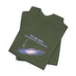 Folded military green t-shirt with graphic of the Milky Way galaxy with an arrow pointing to it and text that says "YOU ARE HERE - Paying taxes to pedophiles" by empowHER by Heidi