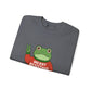 Folded gray sweatshirt with the Portland protest frog wearing a sweater displaying 'Merry Resistmas' by empowHERbyHeidi