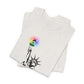 Folded white t-shirt with the Statue of Liberty and rainbow Pride colors emitting from her torch by empowHER by Heidi