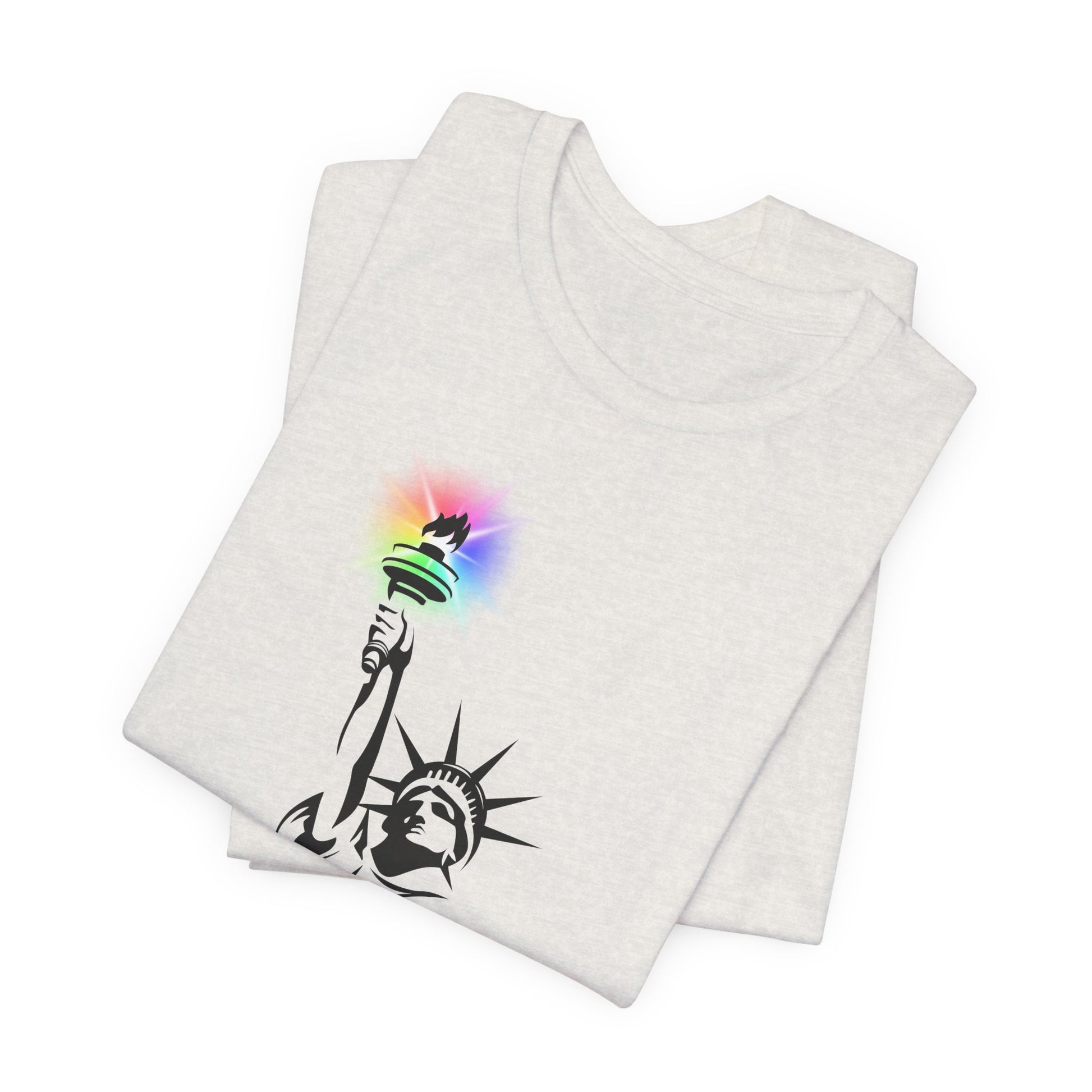 Folded white t-shirt with the Statue of Liberty and rainbow Pride colors emitting from her torch by empowHER by Heidi