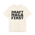 Beige t-shirt with 'DRAFT MAGA FIRST' text on a plain background