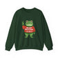 Green sweatshirt with the Portland protest frog wearing a sweater displaying 'Merry Resistmas' by empowHERbyHeidi