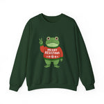 Green sweatshirt with the Portland protest frog wearing a sweater displaying 'Merry Resistmas' by empowHERbyHeidi