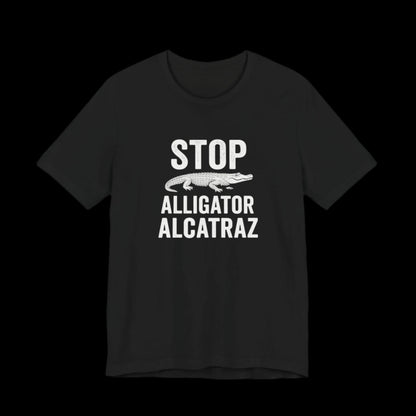 Black t-shirt with white text 'STOP Alligator Alcatraz' on a black background