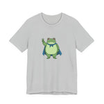 Gray t-shirt with a bold graphic of the Portland protest frog—red eyes, blue cape, and unimpressed face by empowHERbyHeidi