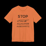 Orange t-shirt with black ext that says "STOP ALLIGATOR AUSCHW*TZ" with alligator graphic on a black background