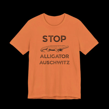 Orange t-shirt with black ext that says "STOP ALLIGATOR AUSCHW*TZ" with alligator graphic on a black background