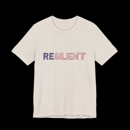 Beige t-shirt with 'RESILIENT' text in red, white, and blue American Flag letters on a plain background