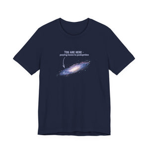 Navy blue t-shirt with graphic of the Milky Way galaxy with an arrow pointing to it and text that says "YOU ARE HERE - Paying taxes to pedophiles" by empowHER by Heidi