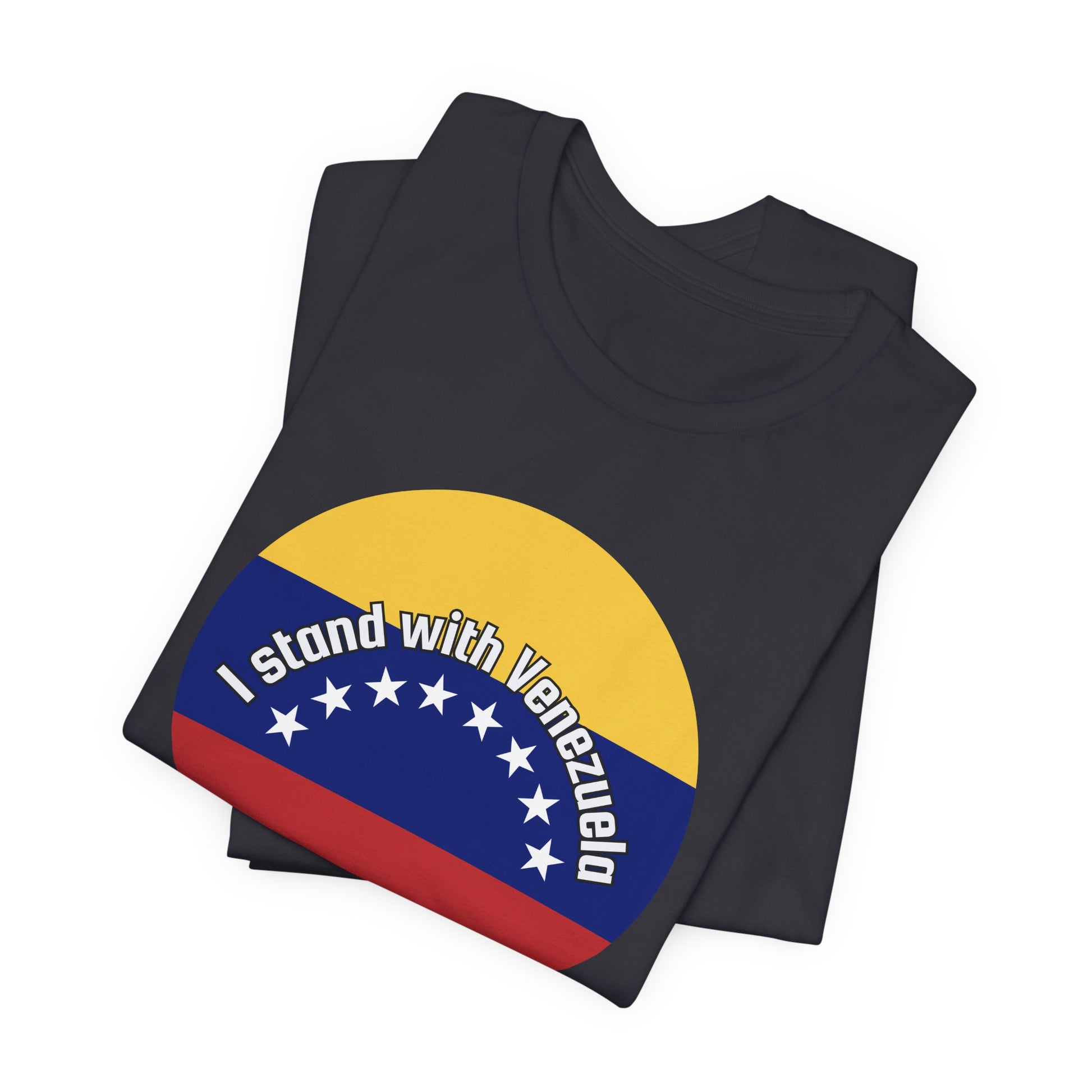 Folded dark gray t-shirt with a circular design featuring the Venezuelan flag and 'I stand with Venezuela' text by empowHER by Heidi