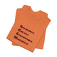 Folded orange t-shirt with blue text 'Solidarity Creates Unstoppable Movements' by empowHER by Heidi