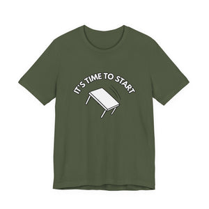 Military green t-shirt with a flipping table graphic and text "It's time to start" by empowHER by Heidi