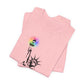 Folded pink t-shirt with the Statue of Liberty and rainbow Pride colors emitting from her torch by empowHER by Heidi
