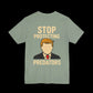 Green t-shirt with a graphic of a person  that looks like the silhouette of trump and text 'Stop Protecting Predators' 