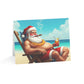 Card with a cartoon Santa Claus lounging on a beach, smoking a cigar and holding a drink.