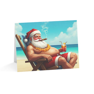 Card with a cartoon Santa Claus lounging on a beach, smoking a cigar and holding a drink.
