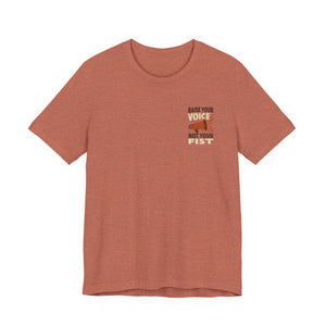 Heather clay t-shirt with a graphic and text "Raise your voice, not your fist" – empowHER by Heidi political protest apparel