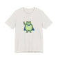 Heather cement t-shirt with a bold graphic of the Portland protest frog—red eyes, blue cape, and unimpressed face by empowHERbyHeidi