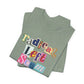 Folded green t-shirt with colorful text "radical left scum" design by empowHER by Heidi