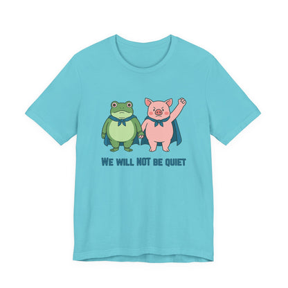 Light blue t-shirt with cartoon frog and pig characters holding hands and text 'WE WILL NOT BE QUIET' on a white background by empowHER by Heidi | protest wear