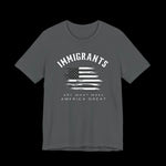 Gray t-shirt with American flag graphic and text that says "Immigrants are what make America Great" on a black background