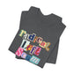 Folded gray t-shirt with colorful text "radical left scum" design by empowHER by Heidi