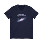 Navy blue v-neck t-shirt with graphic of the Milky Way galaxy with an arrow pointing to it and text that says "YOU ARE HERE - Paying taxes to pedophiles" by empowHER by Heidi