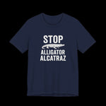 Navy blue t-shirt with white  text and alligator graphic that says "Stop Alligator Alcatraz" on a black background