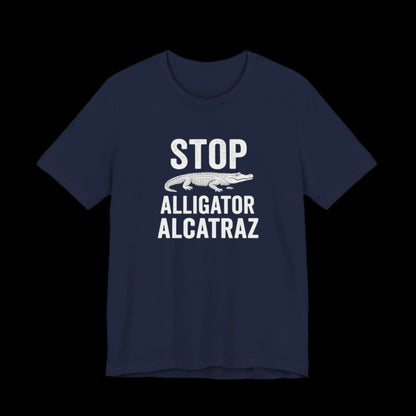 Navy blue t-shirt with white  text and alligator graphic that says "Stop Alligator Alcatraz" on a black background