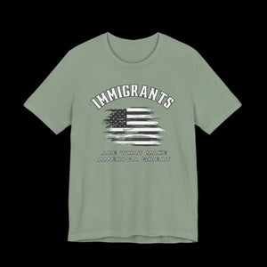 Sage t-shirt with American flag graphic and text that says "Immigrants are what make America Great" on a black background