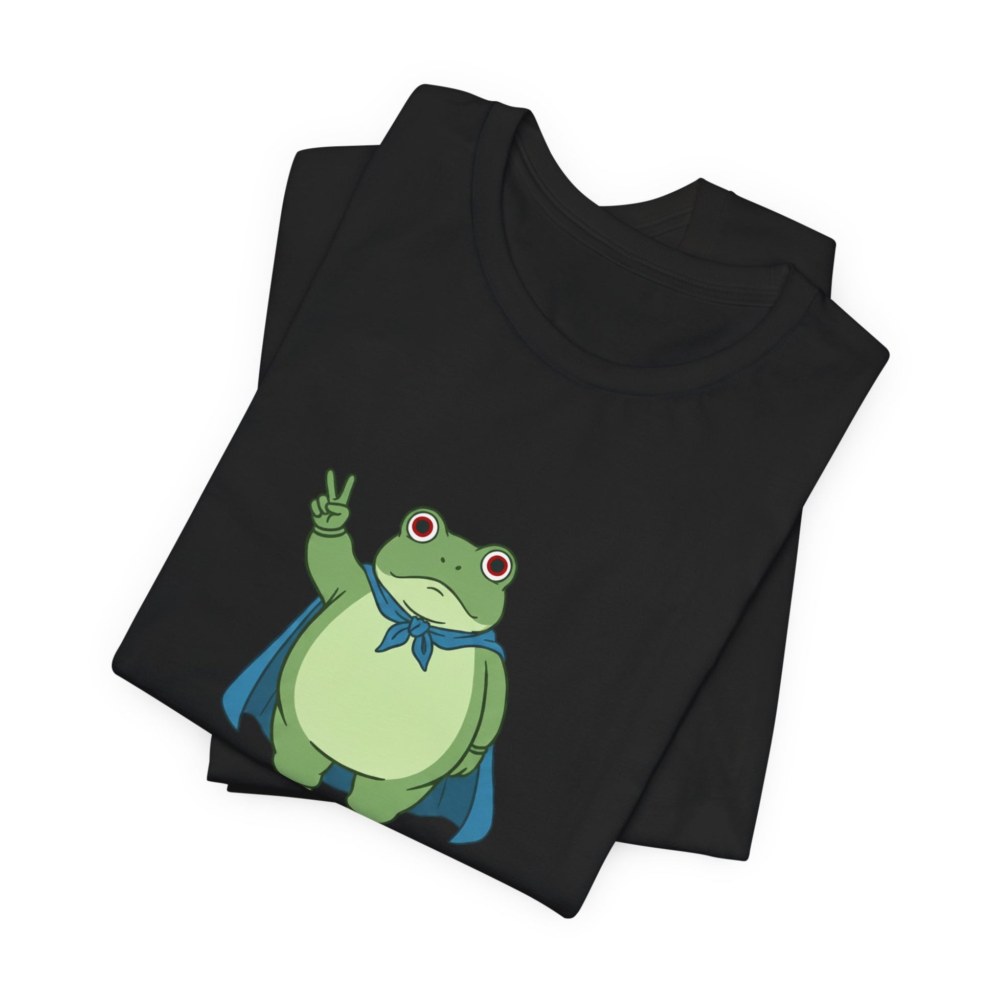 Black t-shirt with a bold graphic of the Portland protest frog—red eyes, blue cape, and unimpressed face by empowHERbyHeidi