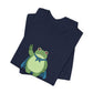 Folded navy t-shirt with a bold graphic of the Portland protest frog—red eyes, blue cape, and unimpressed face by empowHERbyHeidi