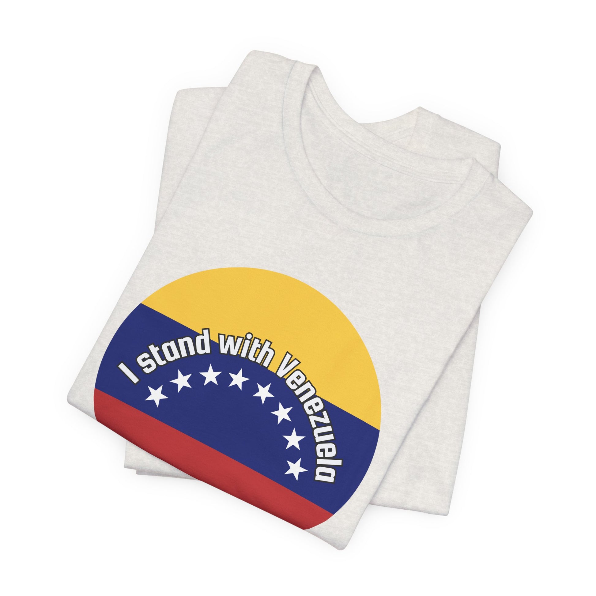 Folded heather cement t-shirt with a circular design featuring the Venezuelan flag and 'I stand with Venezuela' text by empowHER by Heidi