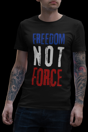 Person wearing a black t-shirt with 'Freedom Not Force' text in an urban setting